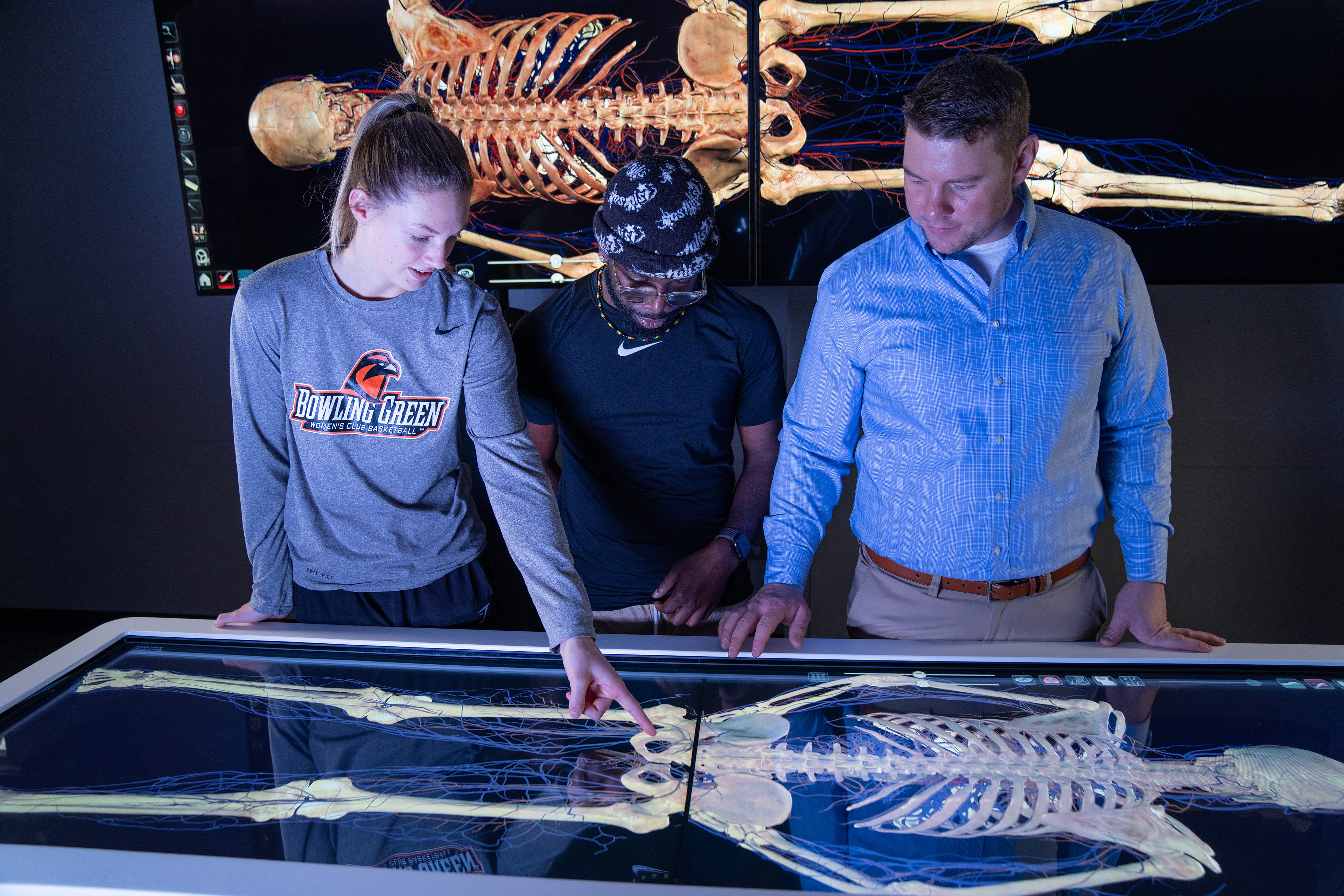 Students stand in front of virtual dissection table.