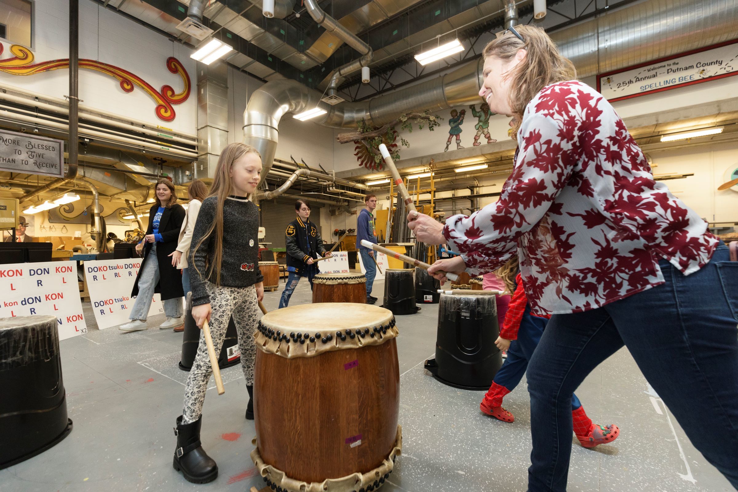 Adult and child playing with a drum