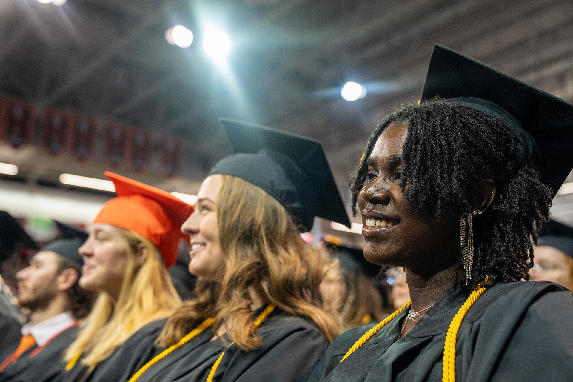 Graduates look toward the stage during Commencement.