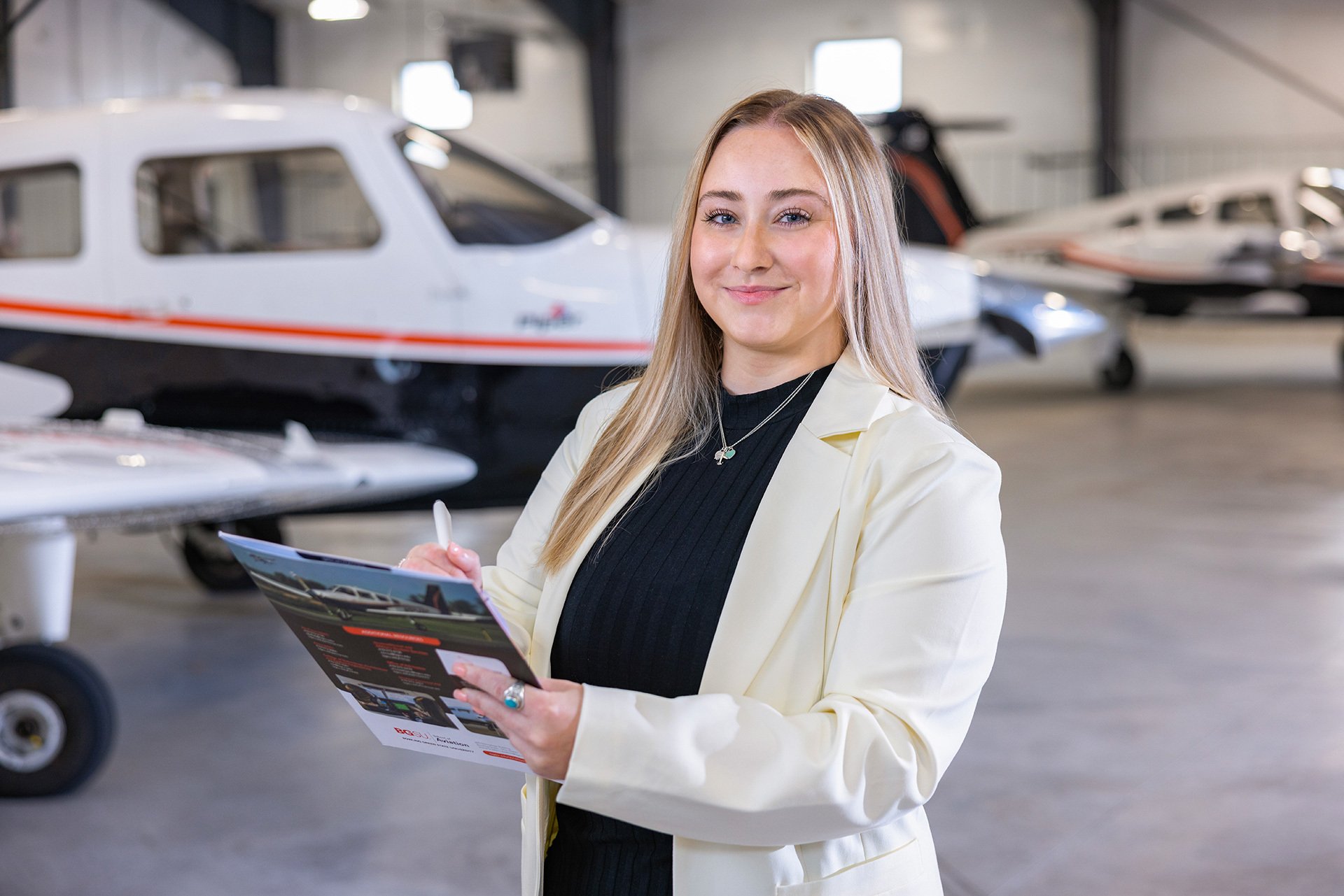 A BGSU student stands in an airplane hangar