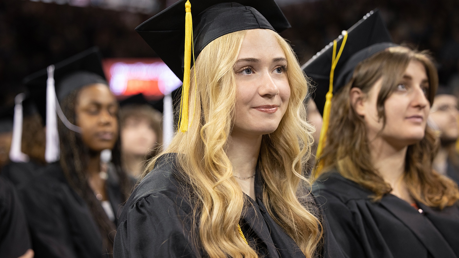 Woman sits at graduation ceremony