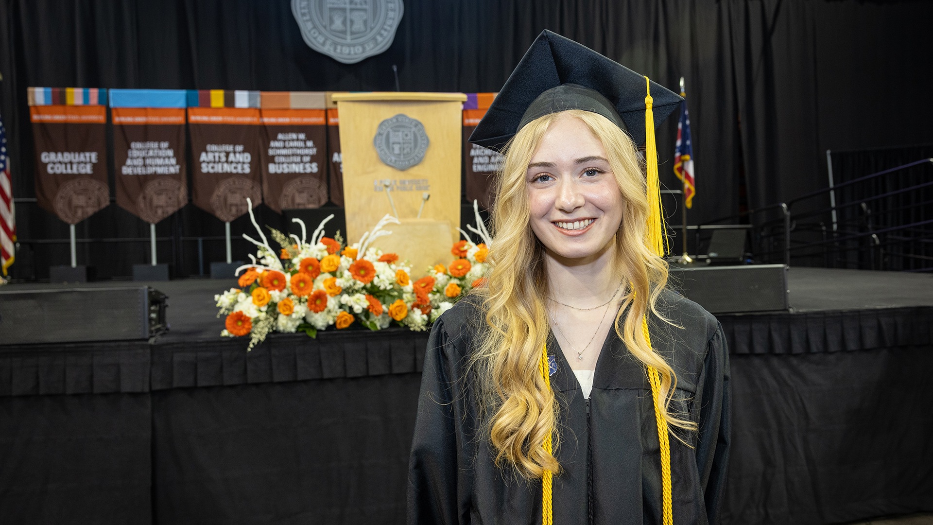 Woman poses for a picture after graduation