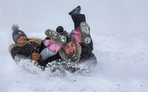 Two students sledding