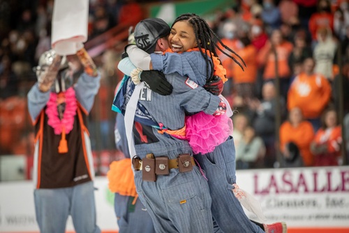 Student mascots hugging