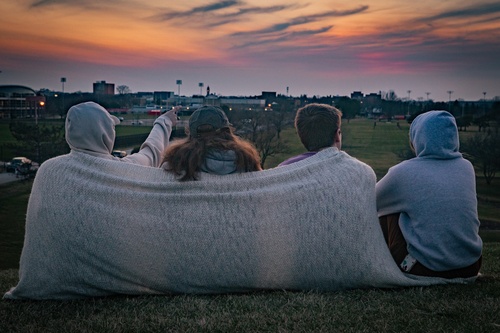 Four students watching the sunset