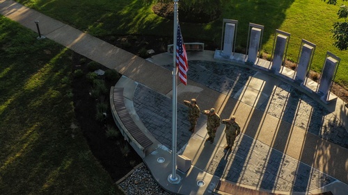 Three military individuals saluting