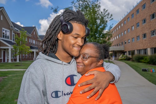 A parent and student hugging