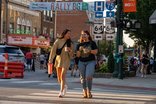 Two individuals walking downtown