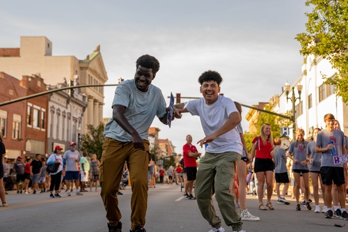 Two individuals walking downtown