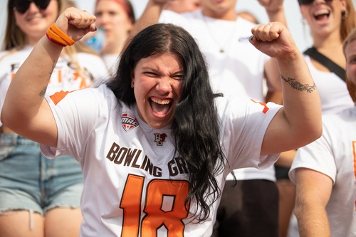 A student cheering at football game