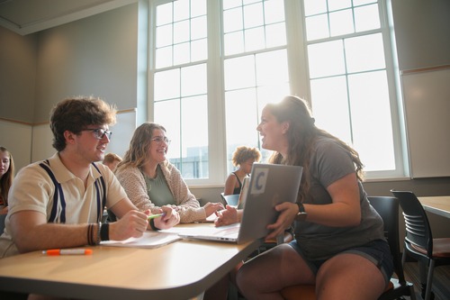 Three students in a classroom