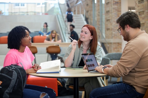 Three students doing homework