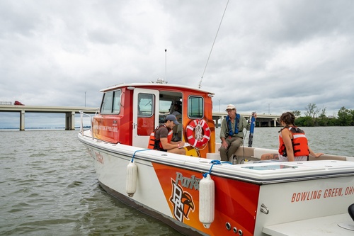 Three individuals in a boat