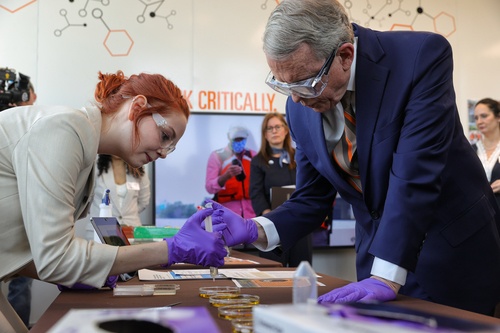 Student and Governor conducting science experiment