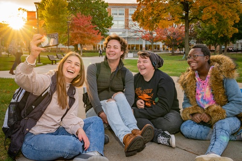 Four students taking a photo together