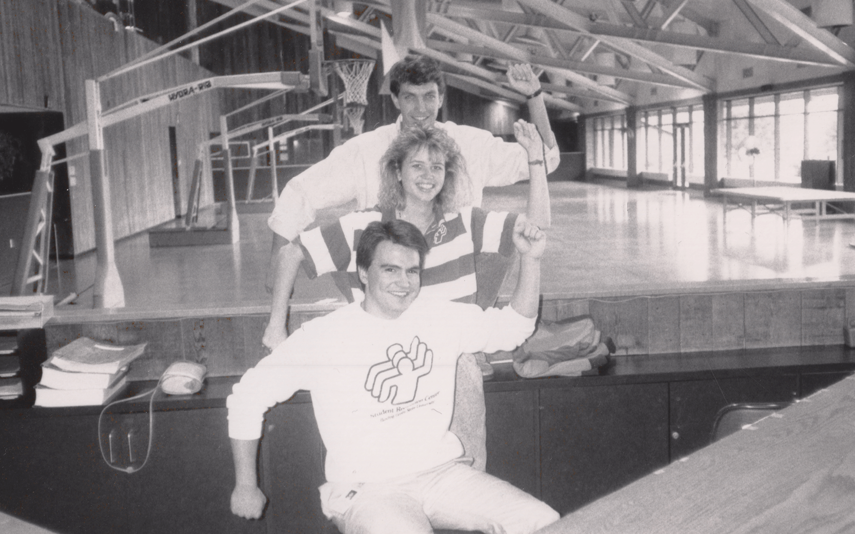 3 student employees forming the original BGSU RecWell logo with their arms