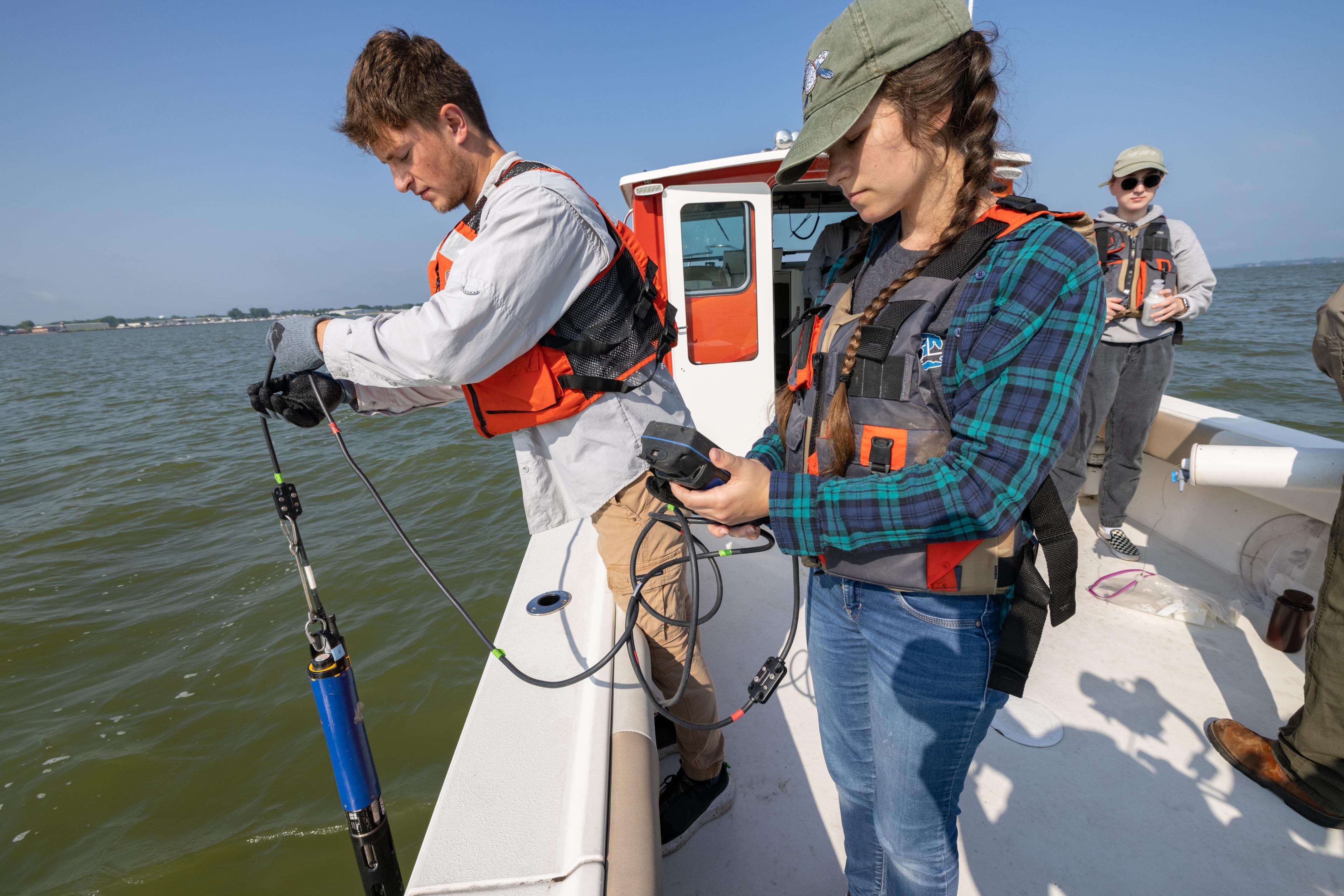 Students collect water samples from Lake Erie aboard the research boat 