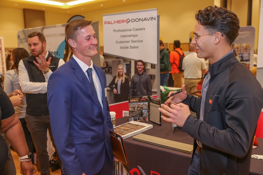 Student talking with recruiter at employment expo