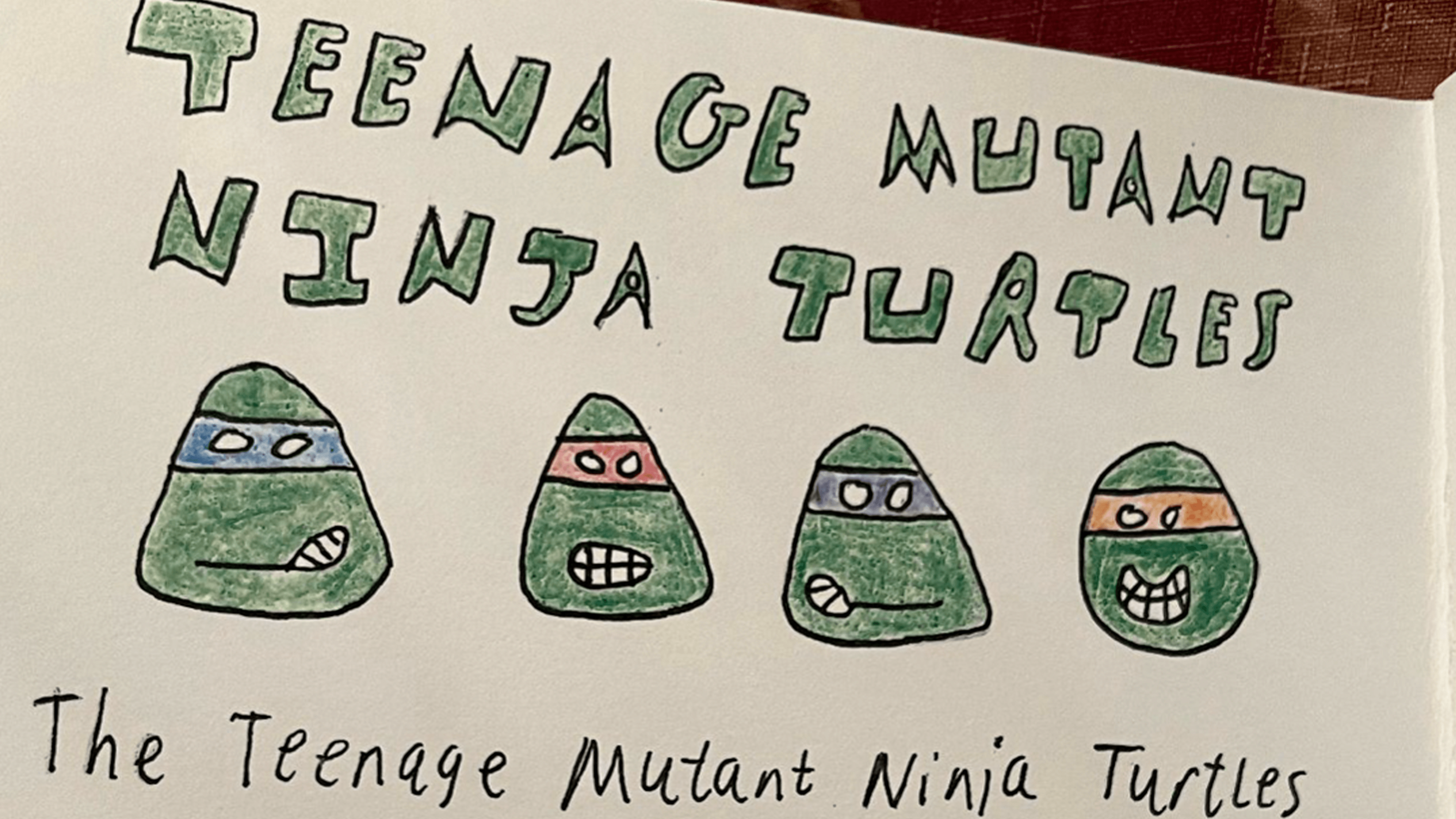 first page of tyler's zine, depicting a drawing of the 4 teenage mutant ninja turtles' heads and the text "teenage mutant ninja turtles"