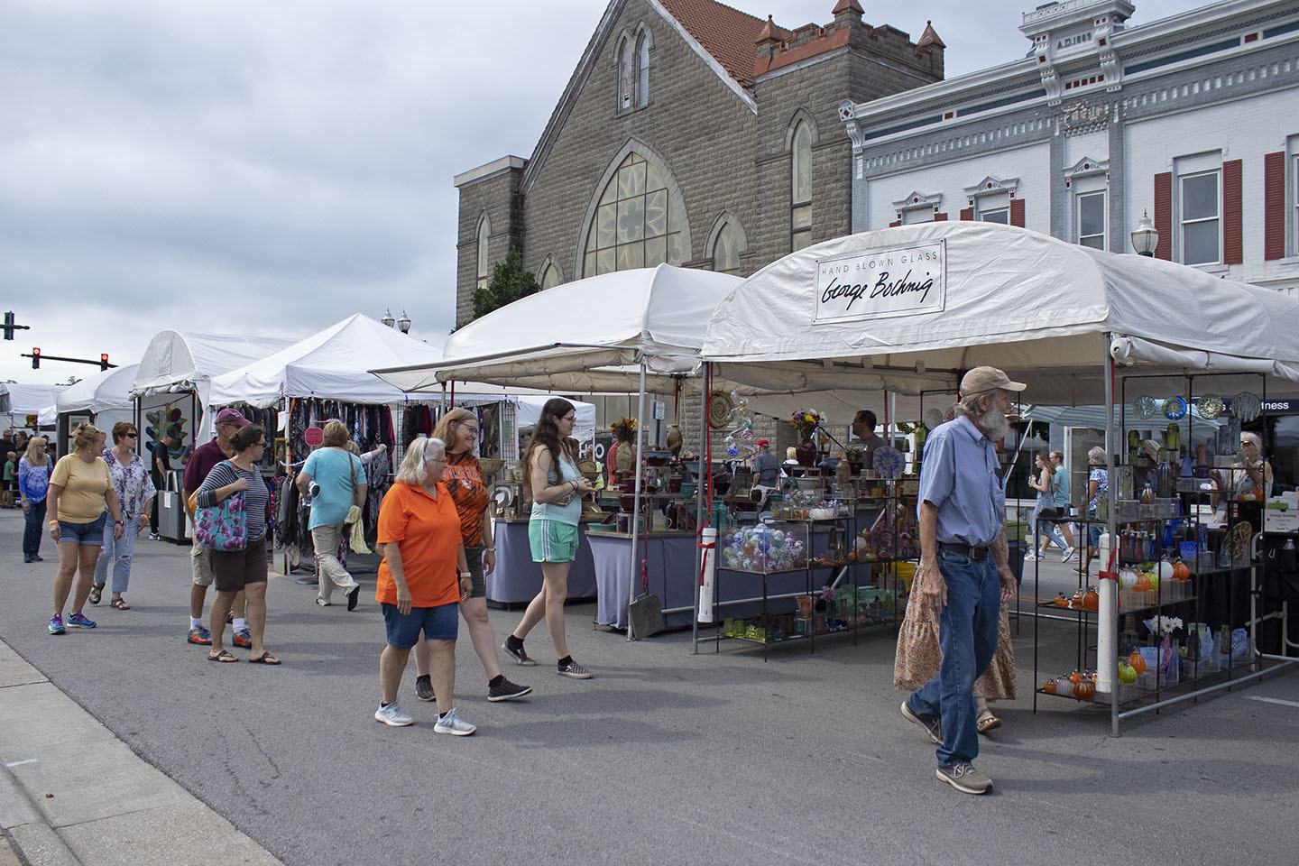 People walking by booths