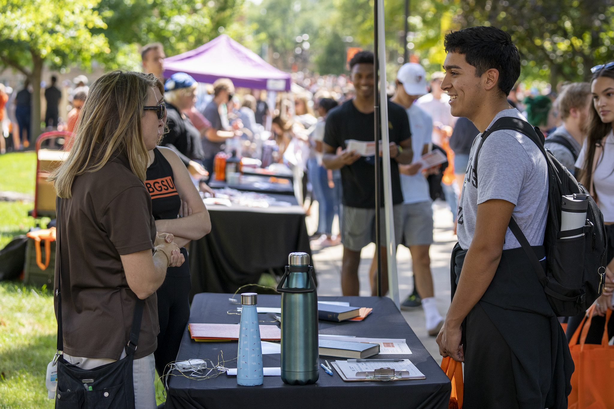 A student answers questions at his exhibitor table.